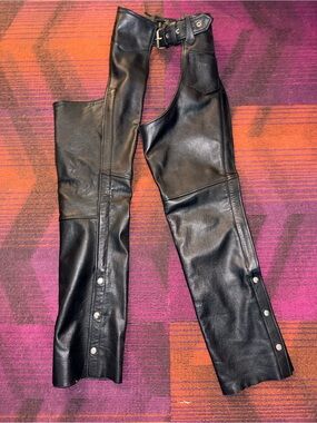 Black Leather Motorcycle Chaps with a Pocket and Snap Details. Adjustable